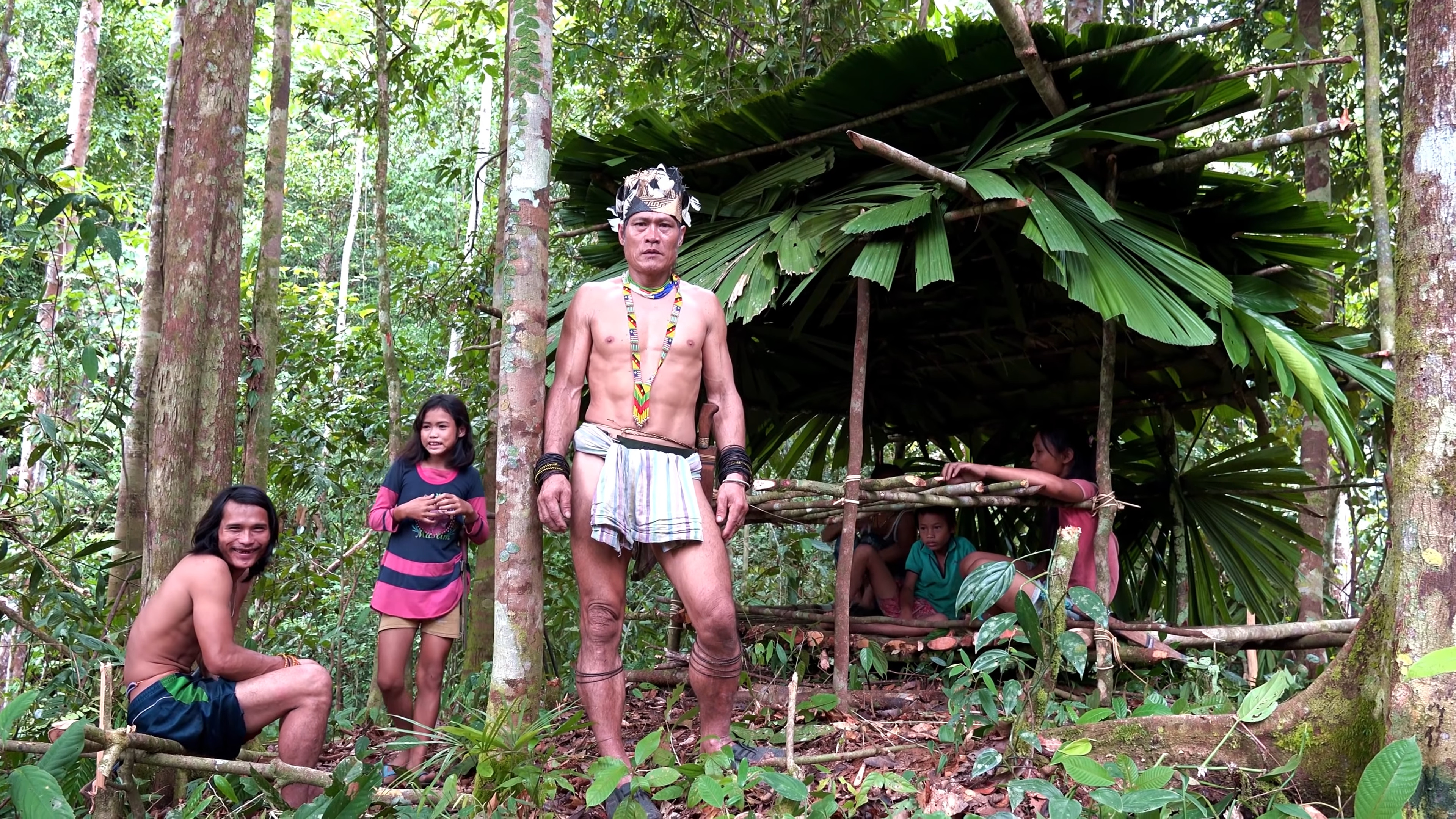 @37m5s Saya and family posing in front of the newly-built shelter